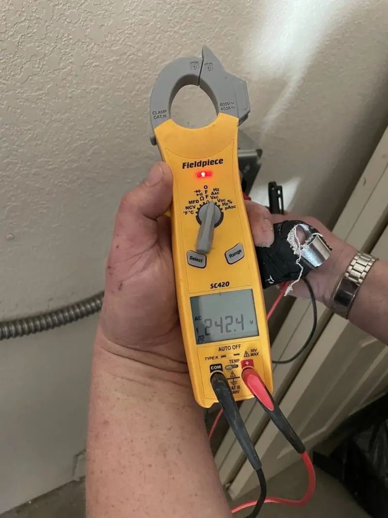Voltage testing with clamp meter during Ceiling Fan Installation in Post Falls